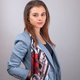 A headshot of Natalie Mayslich in a blue blazer